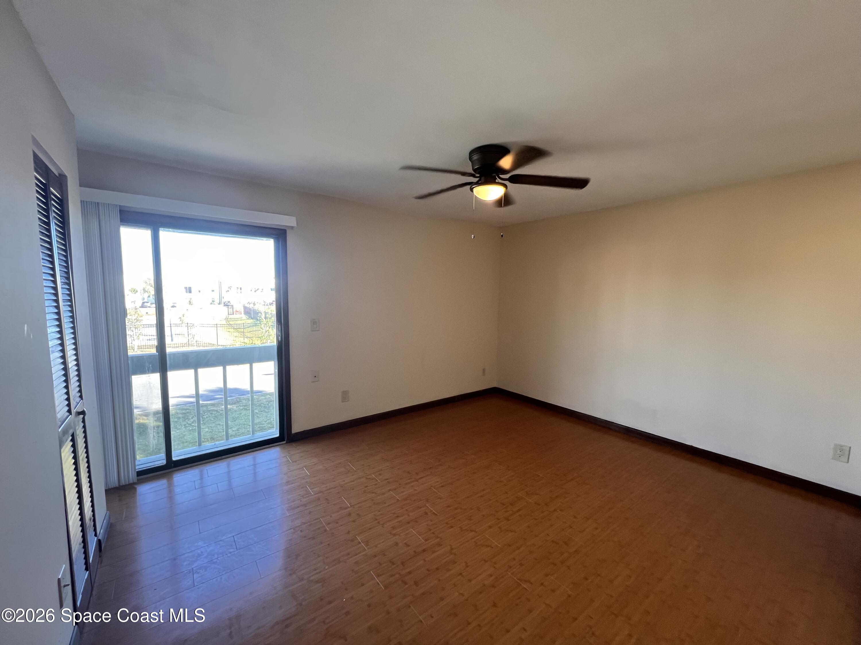 4611 Tree Ridge Lane Northeast Palm Bay, FL 32905 - Photo 19 of 19 an empty room with windows and ceiling fan