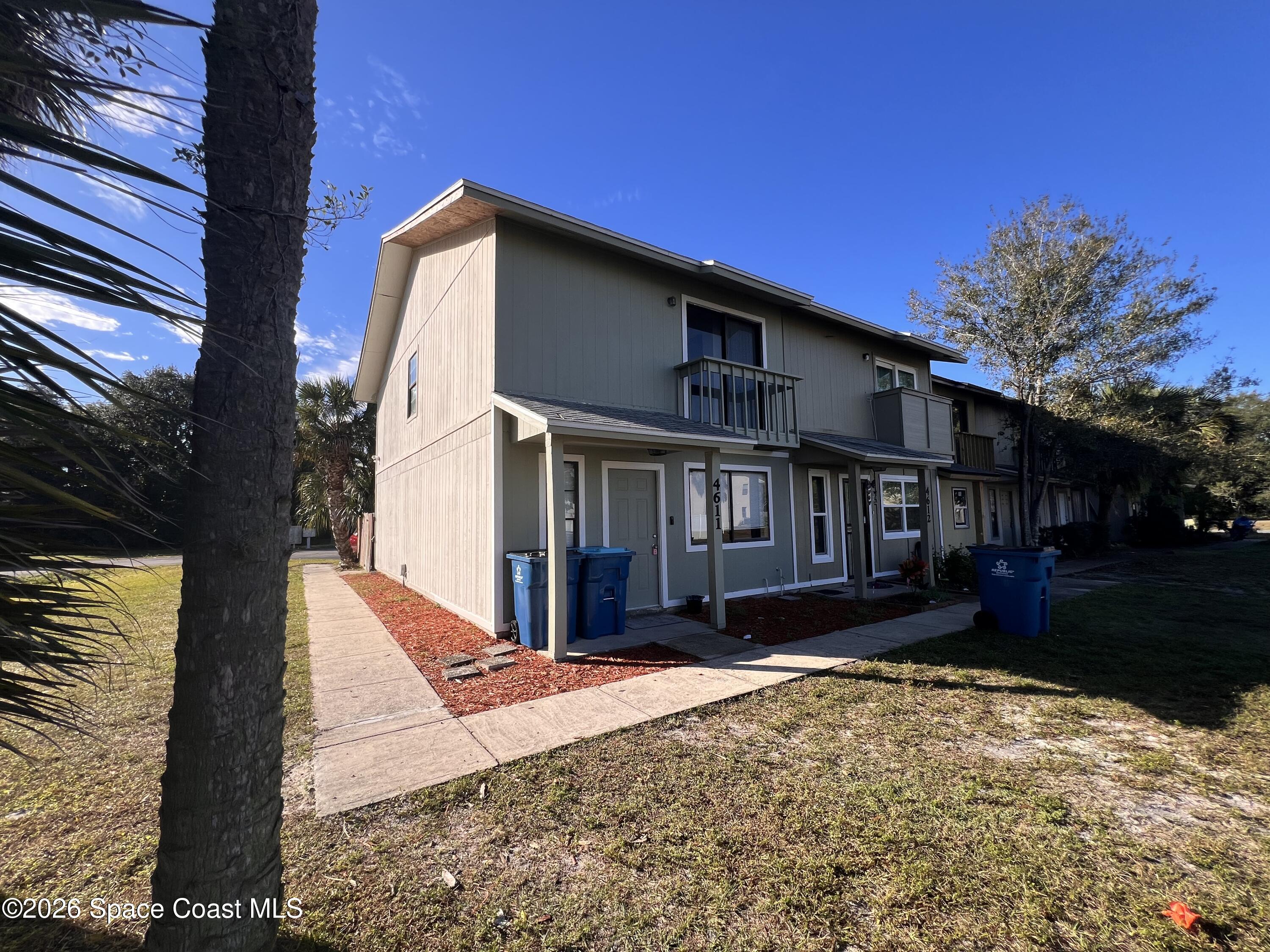 4611 Tree Ridge Lane Northeast Palm Bay, FL 32905 - Photo 2 of 19 a front view of a house with a yard