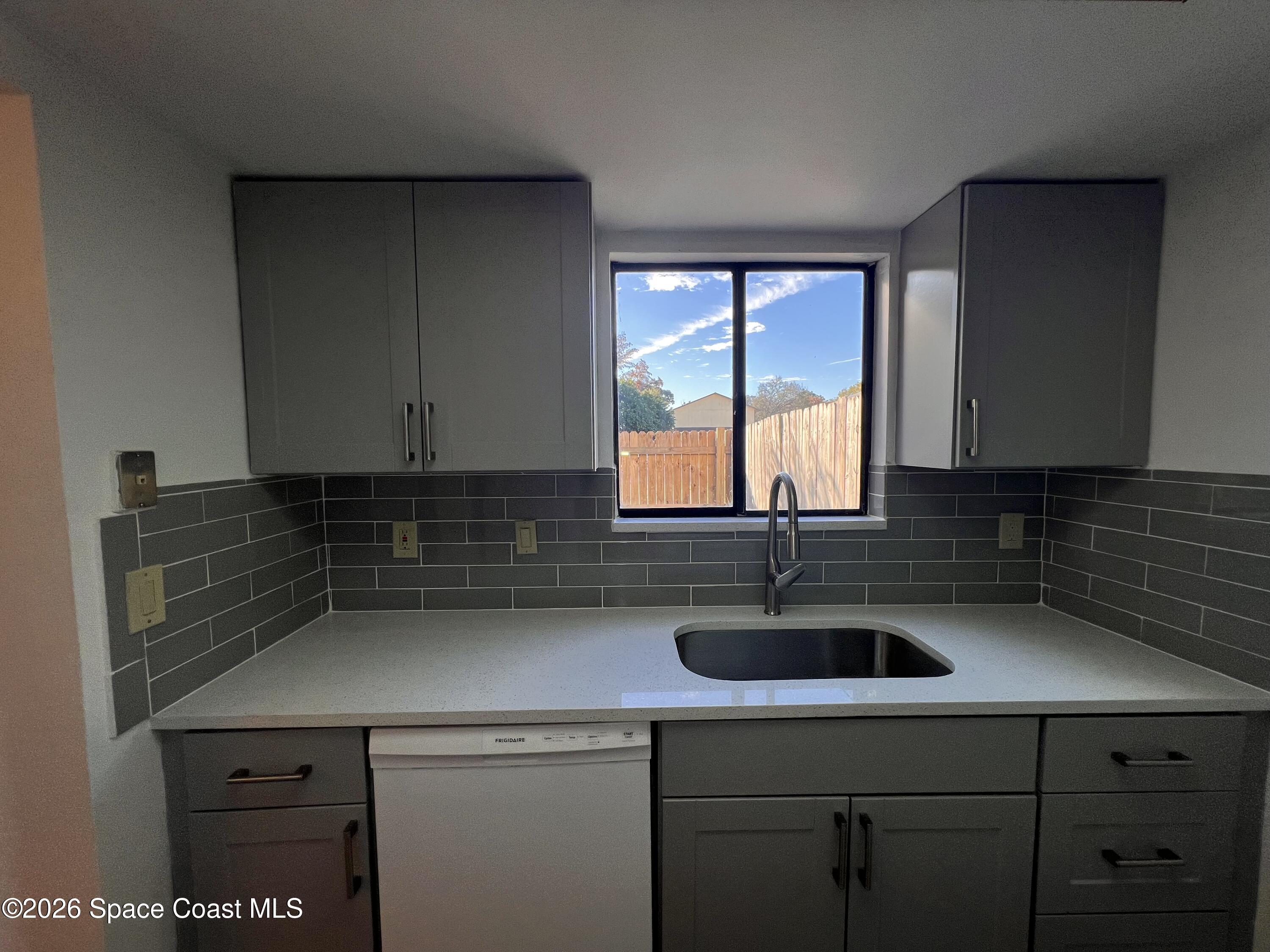 4611 Tree Ridge Lane Northeast Palm Bay, FL 32905 - Photo 8 of 19 a kitchen with a sink and cabinets