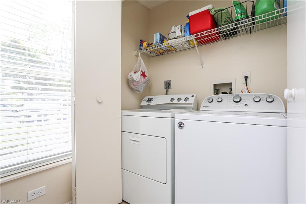 287 Quail Forest Boulevard, Unit 117 Naples, FL 34105 - Photo 15 of 29 a utility room with dryer and washer