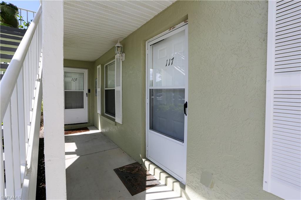 287 Quail Forest Boulevard, Unit 117 Naples, FL 34105 - Photo 20 of 29 a view of a hallway with wooden floor and a bathroom