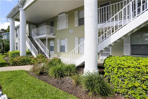 a front view of a multi story building with yard
