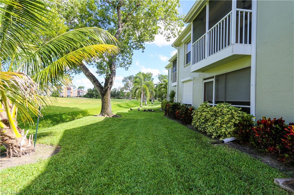 287 Quail Forest Boulevard, Unit 117 Naples, FL 34105 - Photo 23 of 29 a view of a house with a yard