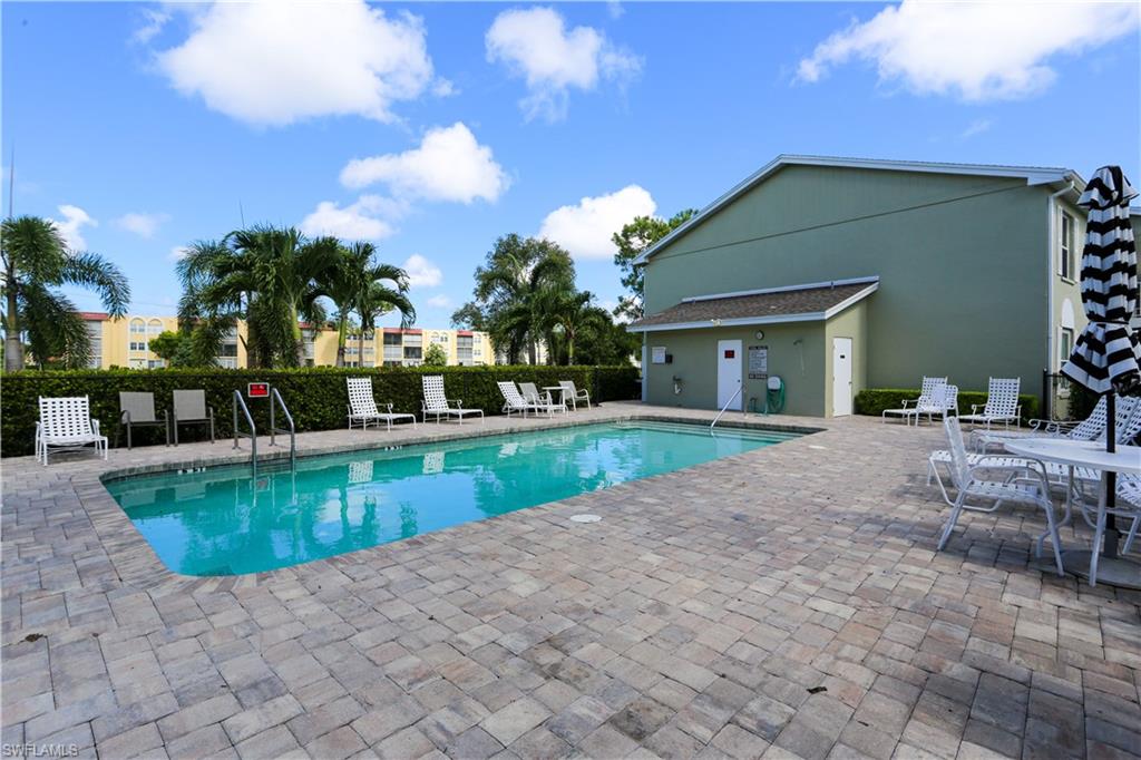 287 Quail Forest Boulevard, Unit 117 Naples, FL 34105 - Photo 25 of 29 a view of a house with swimming pool