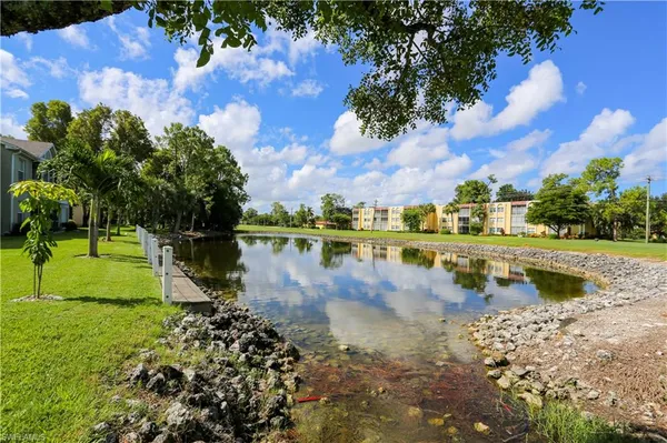 a view of a lake with houses in the background