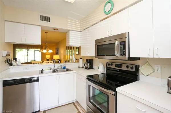 a kitchen with a sink a stove and cabinets