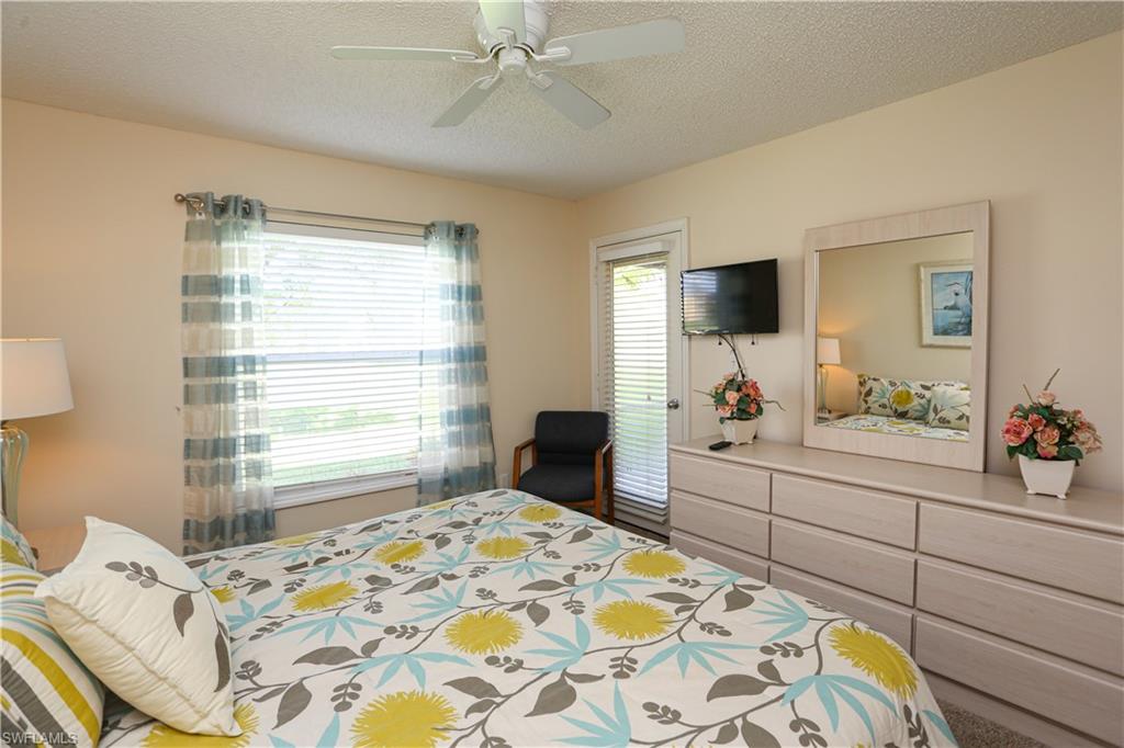 287 Quail Forest Boulevard, Unit 117 Naples, FL 34105 - Photo 10 of 29 a bedroom with a bed and a window