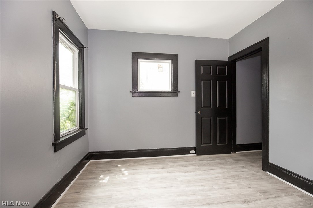 1868-1870 Lampson Road Cleveland, OH 44112 - Photo 36 of 36 Interior room featuring light gray walls, dark trim, and light wood-finish flooring