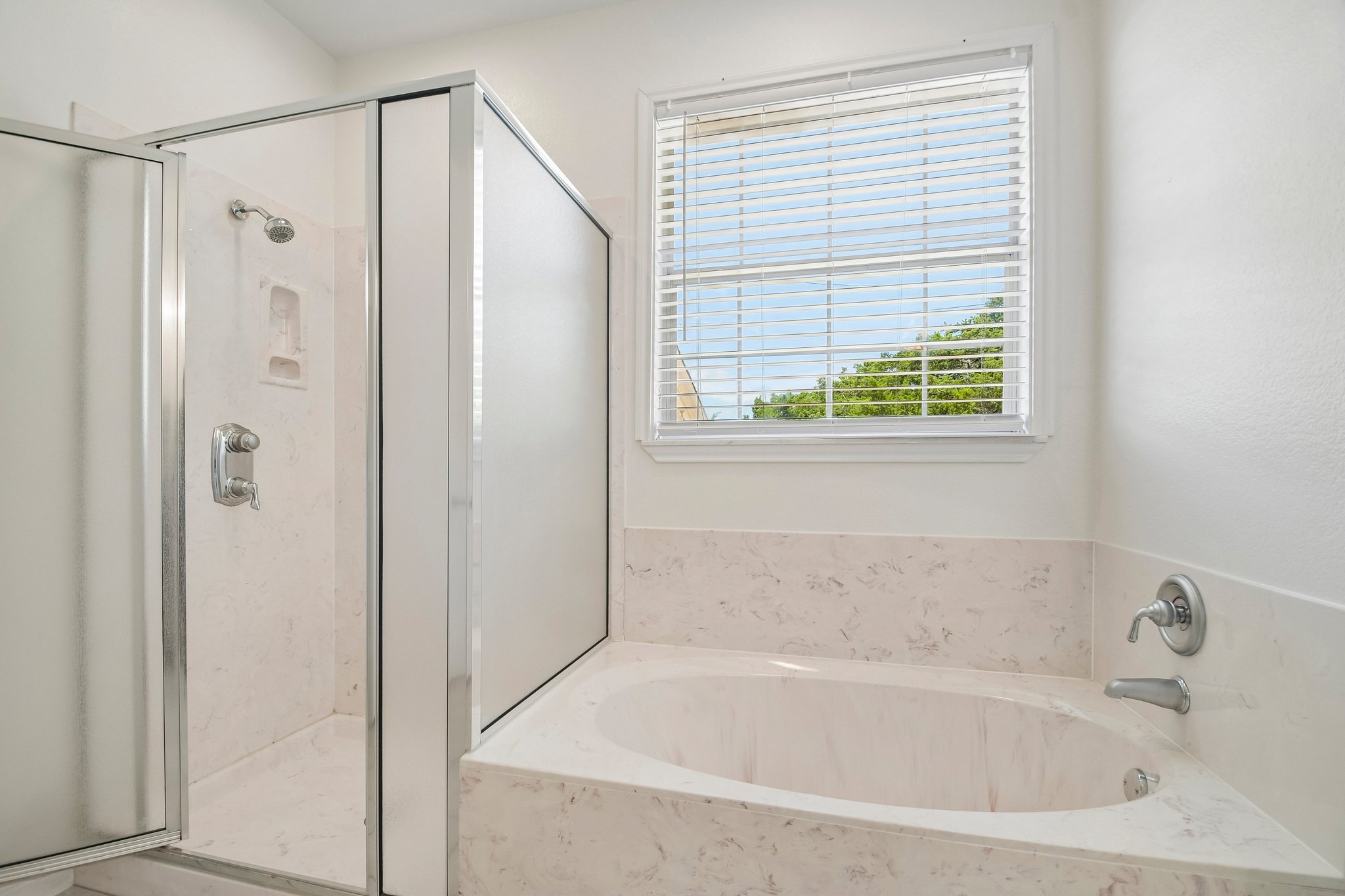 20609 Bridle Path Road Lago Vista, TX 78645 - Photo 5 of 30 Indulge in a tranquil bathing experience with this deep soaking tub and adjacent shower enclosure.