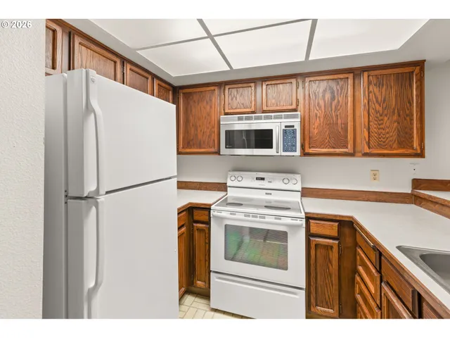 a kitchen with a refrigerator stove and microwave