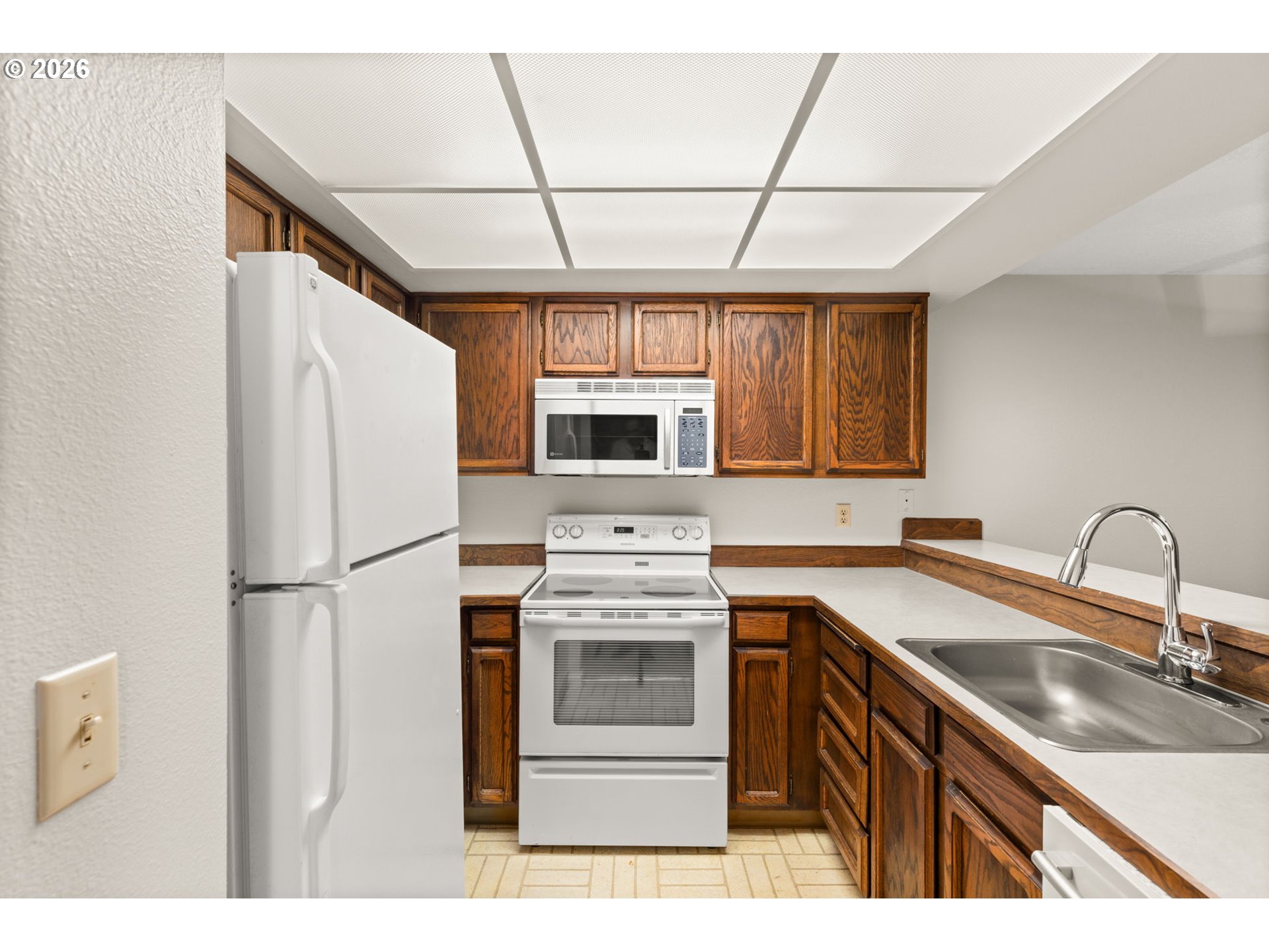 14720 Southwest Grayling Lane Beaverton, OR 97007 - Photo 14 of 32 a kitchen with stainless steel appliances a refrigerator sink and cabinets