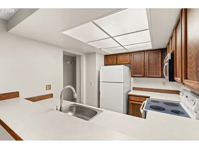 a kitchen with furniture a refrigerator and a sink