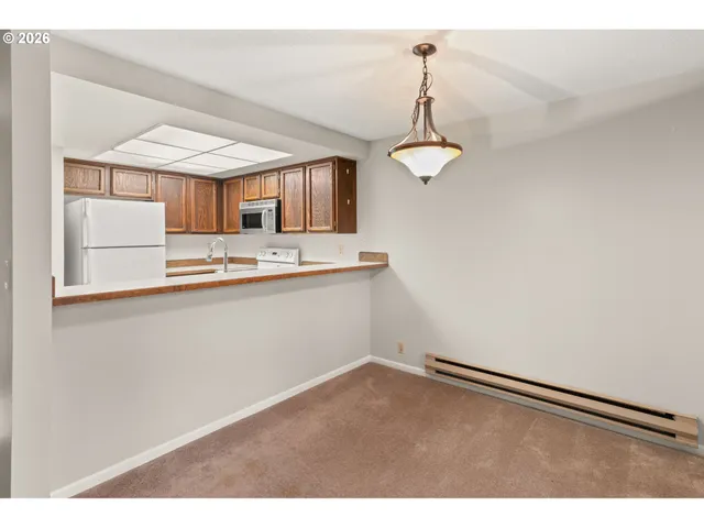 a kitchen with kitchen island stainless steel appliances a sink and a refrigerator