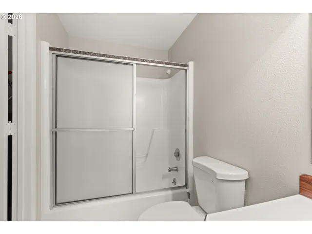 a bathroom with a shower and a toilet
