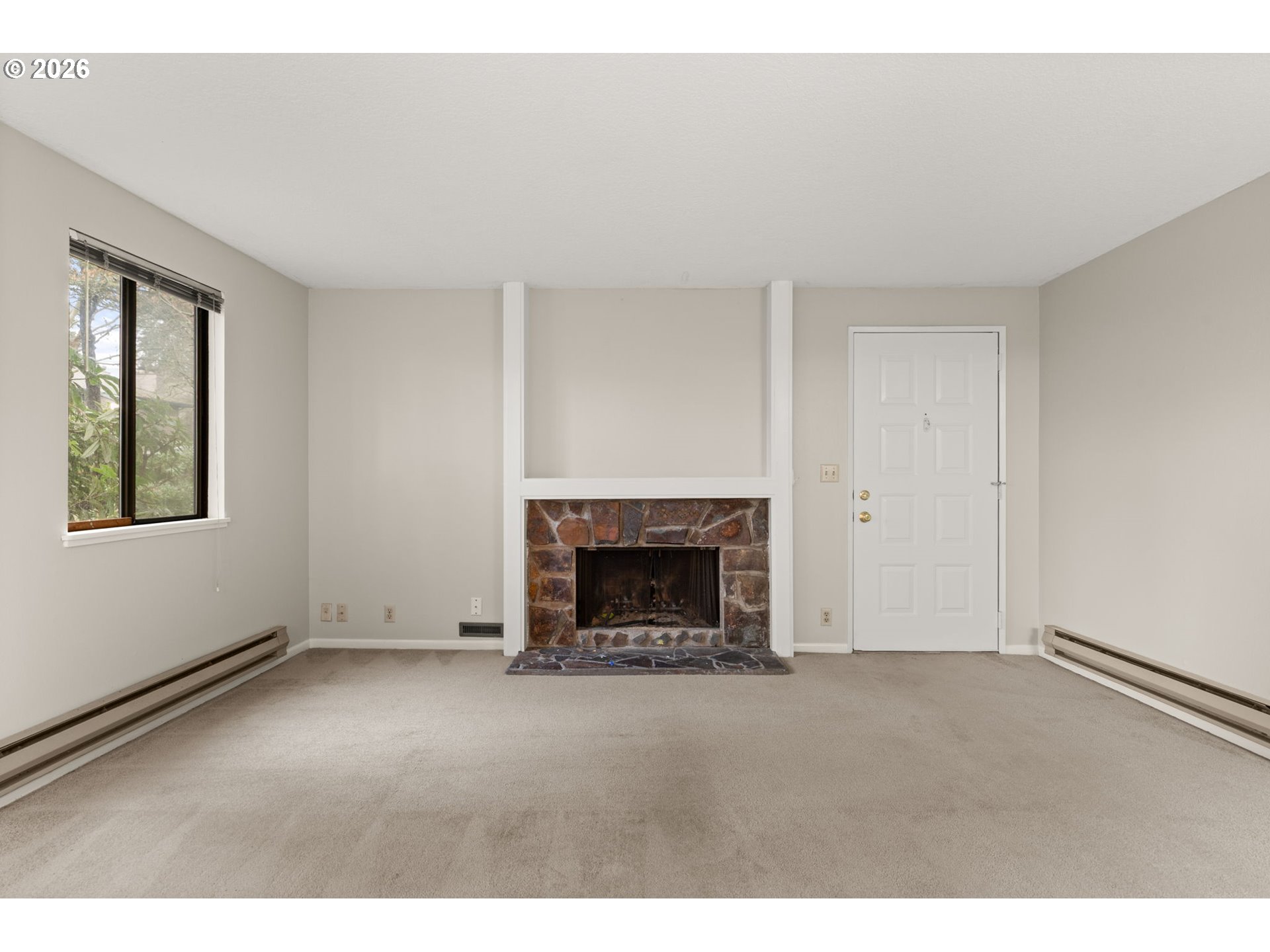 14720 Southwest Grayling Lane Beaverton, OR 97007 - Photo 3 of 32 an empty room with fireplace and a window