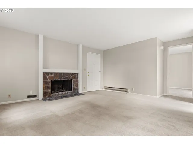 a view of an empty room with a fireplace