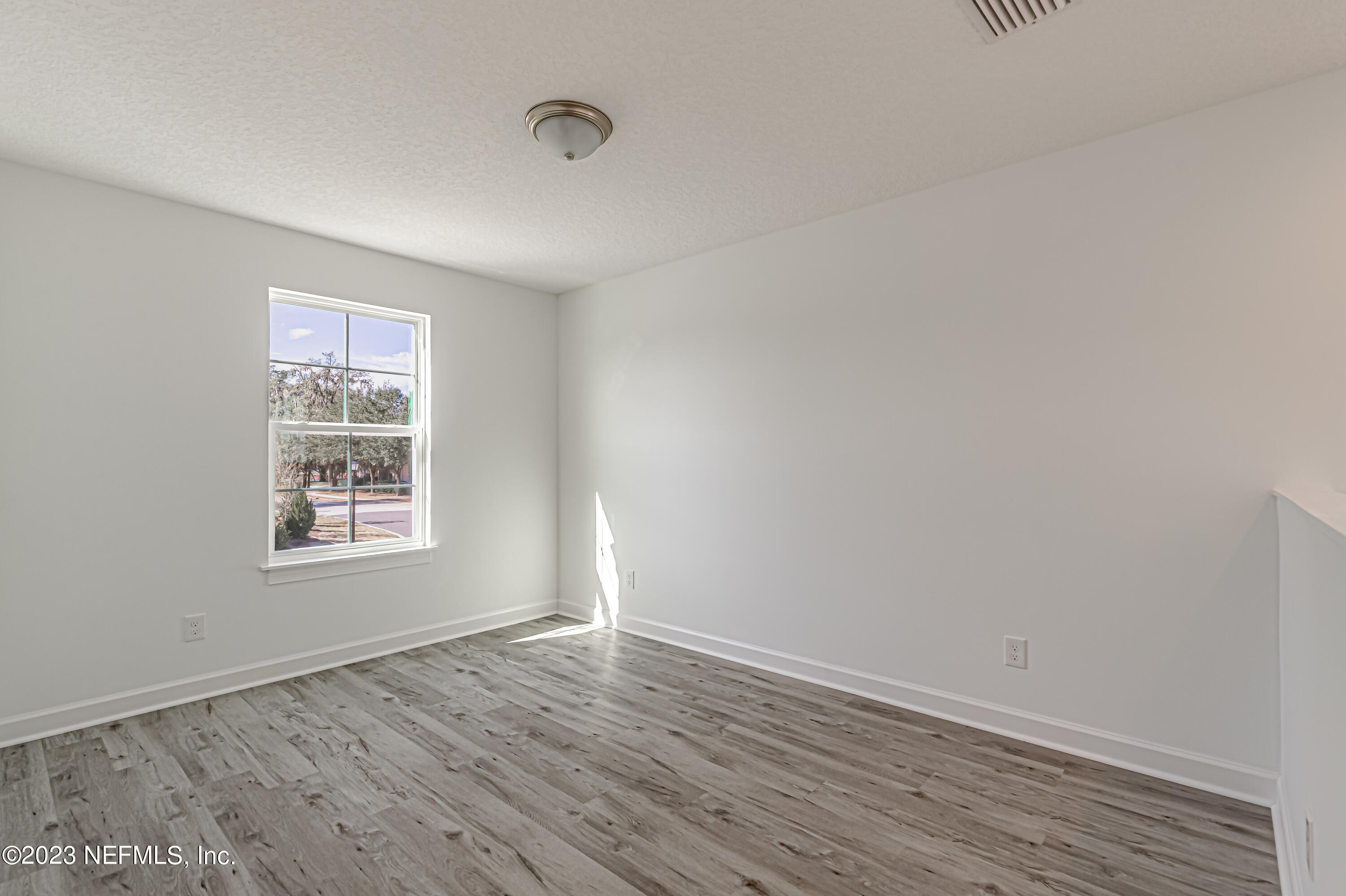 3057 Orange Picker Road Jacksonville, FL 32223 - Photo 11 of 21 wooden floor in an empty room with a window