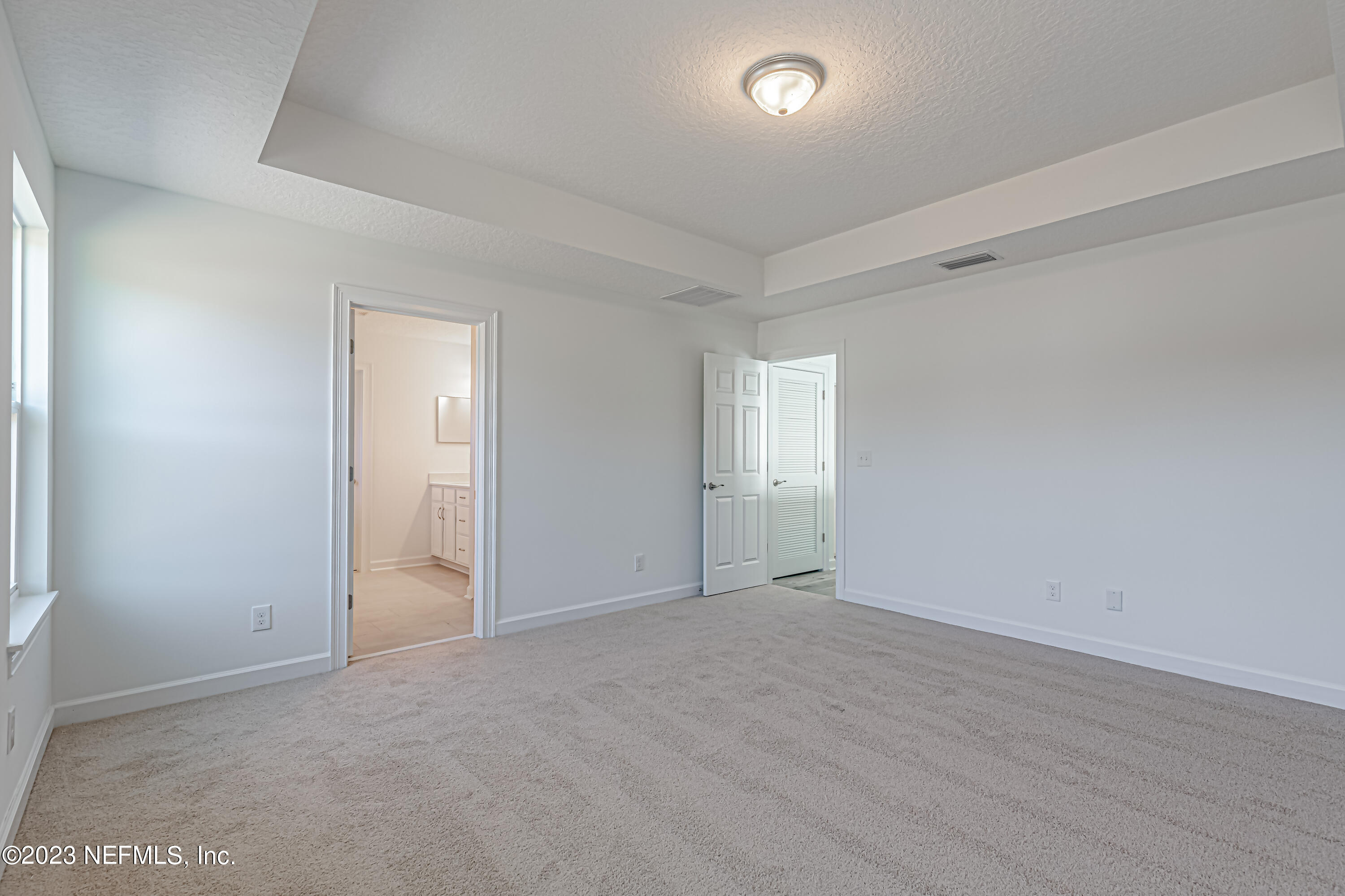 3057 Orange Picker Road Jacksonville, FL 32223 - Photo 14 of 21 an empty room with wooden floor and windows