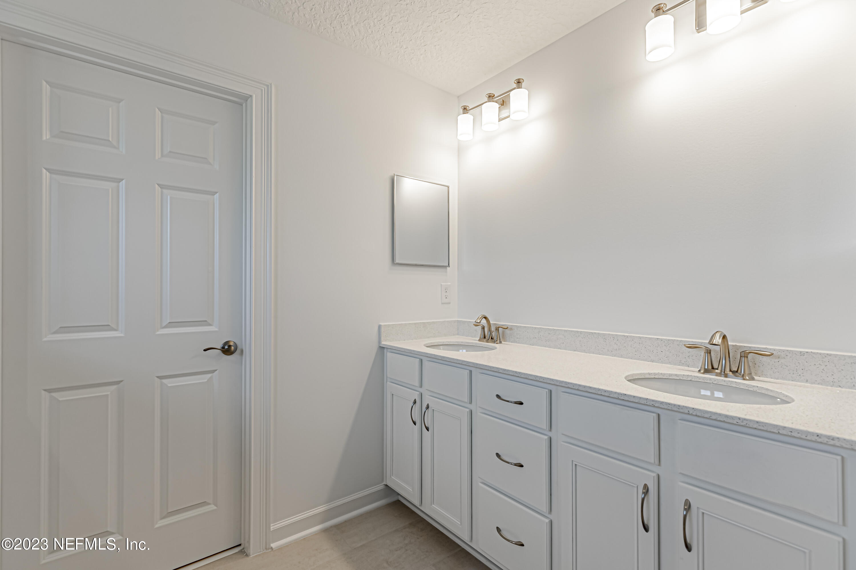 3057 Orange Picker Road Jacksonville, FL 32223 - Photo 15 of 21 a bathroom with a double vanity sink and mirror