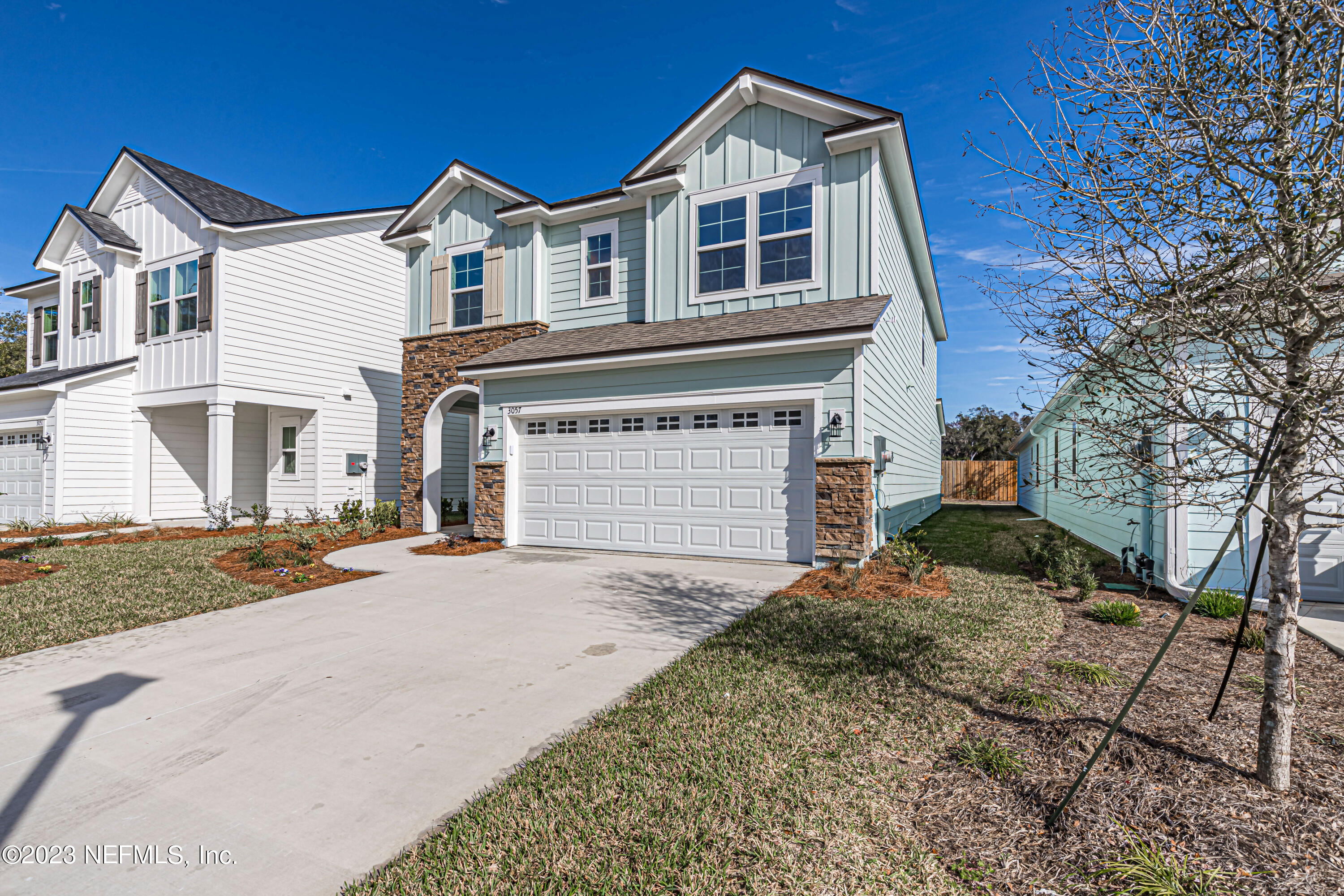 3057 Orange Picker Road Jacksonville, FL 32223 - Photo 2 of 21 a front view of a house with a yard and garage