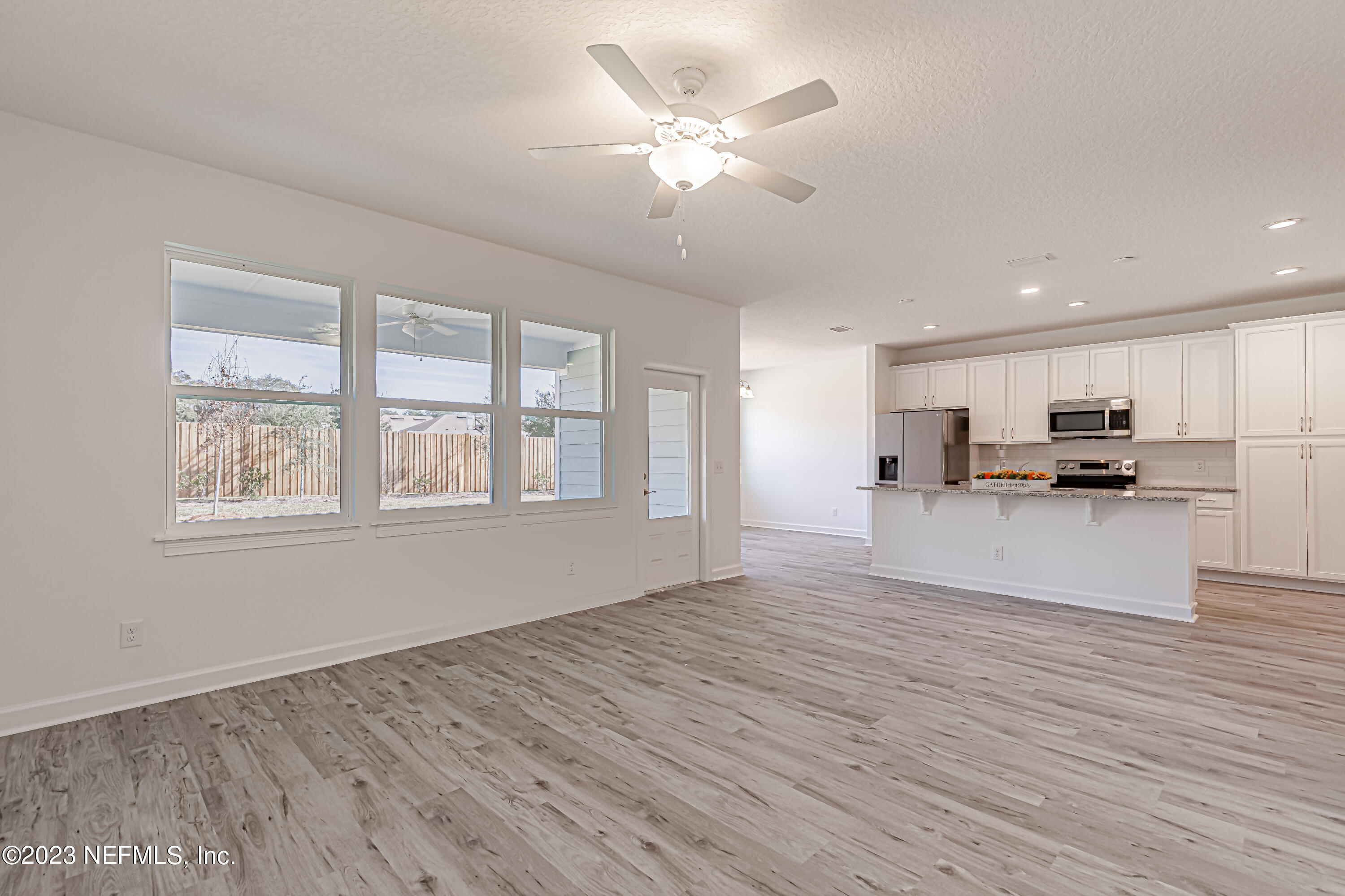 3057 Orange Picker Road Jacksonville, FL 32223 - Photo 4 of 21 a view of kitchen with refrigerator stove and wooden floor