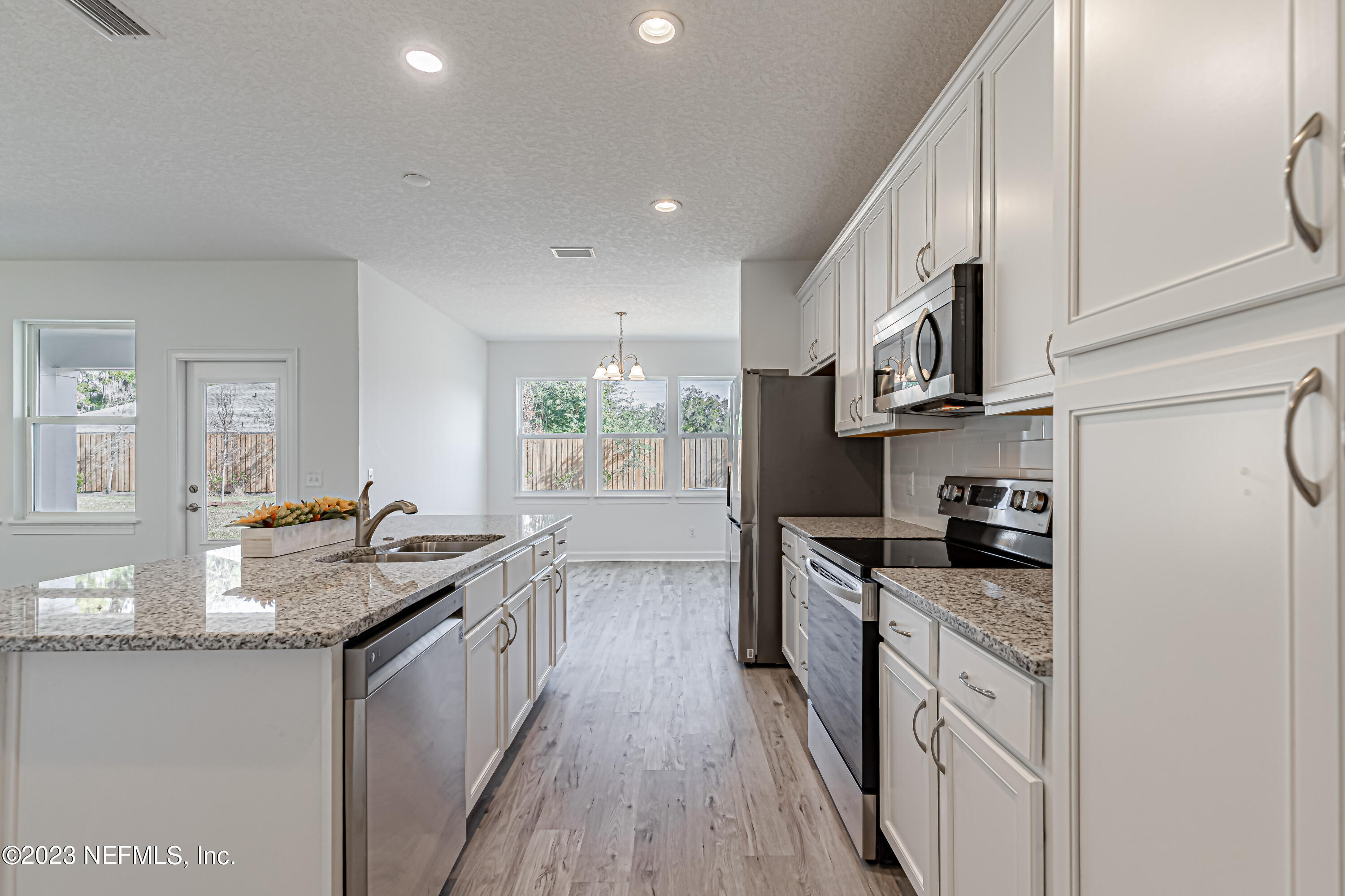 3057 Orange Picker Road Jacksonville, FL 32223 - Photo 8 of 21 a kitchen with stainless steel appliances granite countertop a stove a sink and a refrigerator