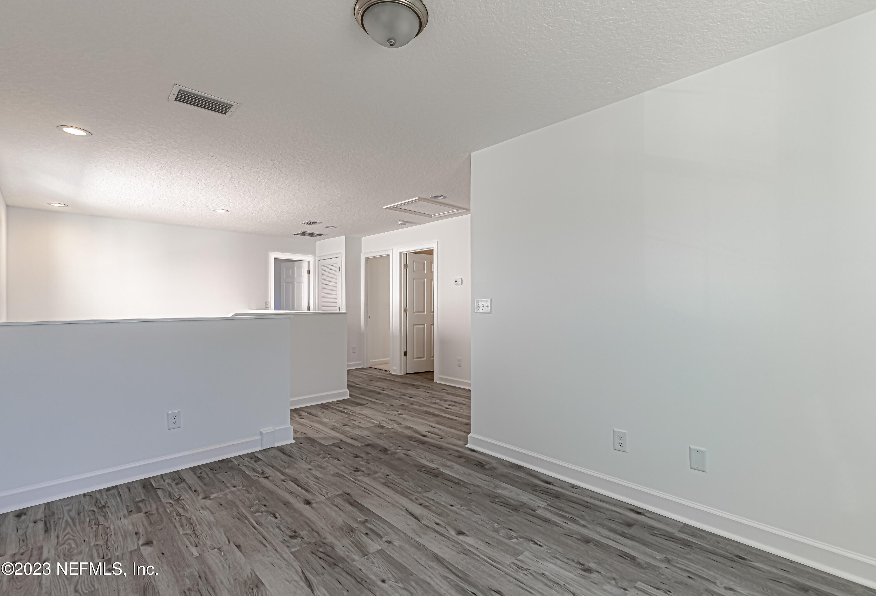 3057 Orange Picker Road Jacksonville, FL 32223 - Photo 10 of 21 a view of a big room with wooden floor and windows