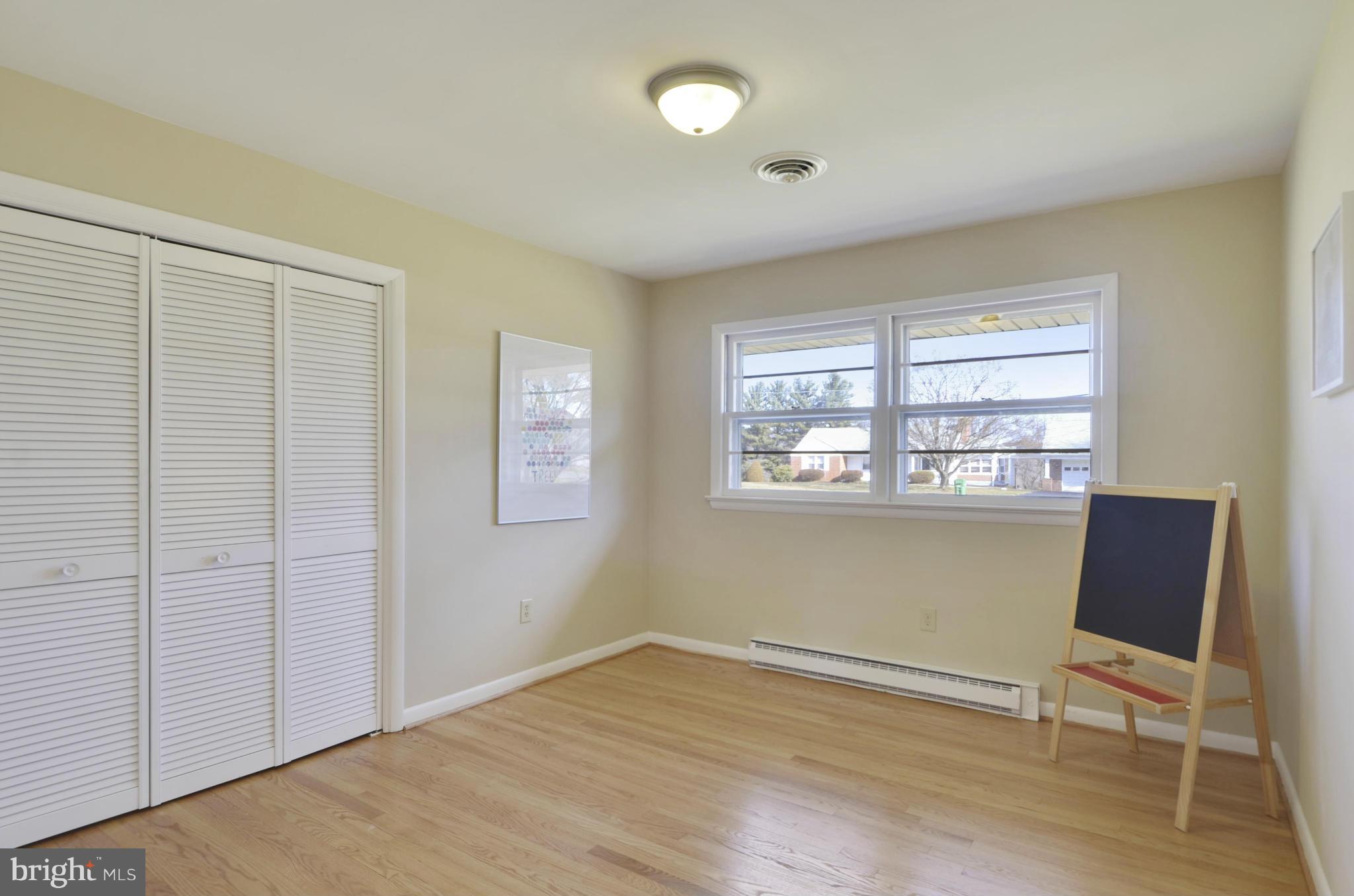 28608 Kemptown Road Damascus, MD 20872 - Photo 16 of 30 a view of a room with wooden floor and windows