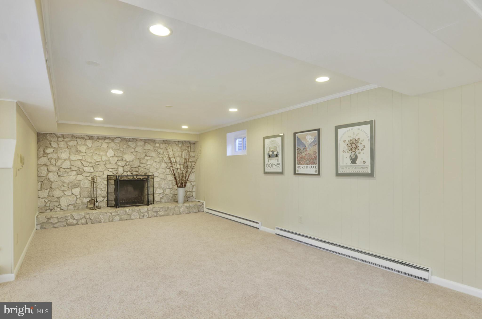 28608 Kemptown Road Damascus, MD 20872 - Photo 19 of 30 an empty room with a fireplace and entryway