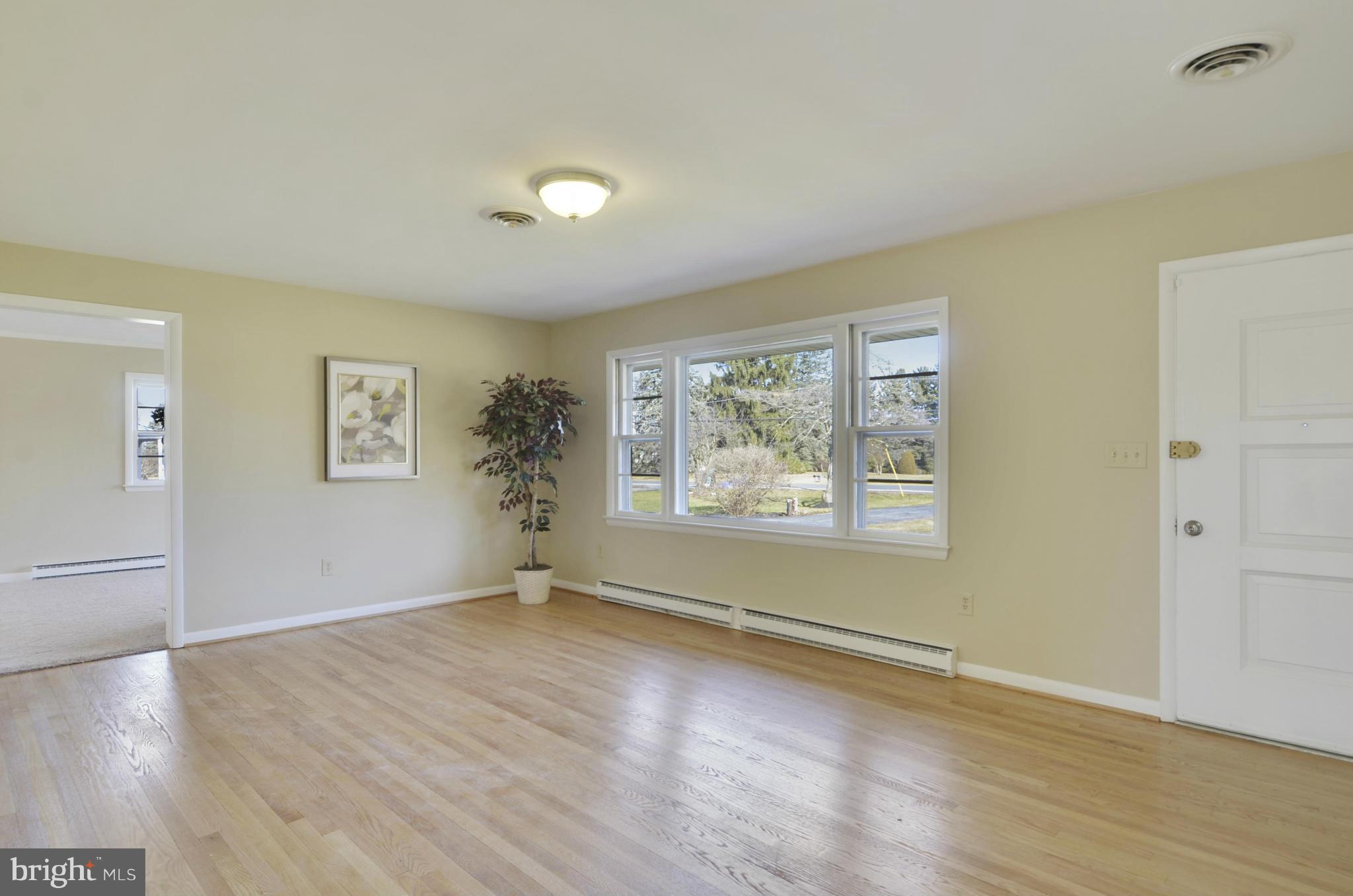 28608 Kemptown Road Damascus, MD 20872 - Photo 3 of 30 an empty room with wooden floor and windows