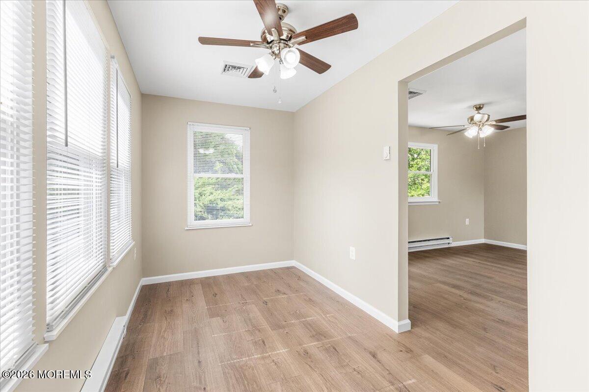 16 D Spring Street, Unit 50 Whiting, NJ 08759 - Photo 6 of 28 an empty room with wooden floor chandelier fan and windows
