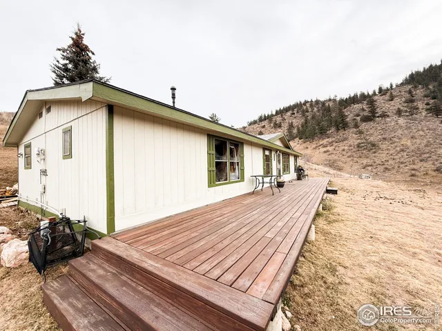 a view of a house with a wooden deck