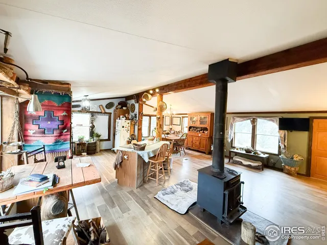 a living room with lots of furniture and a large window