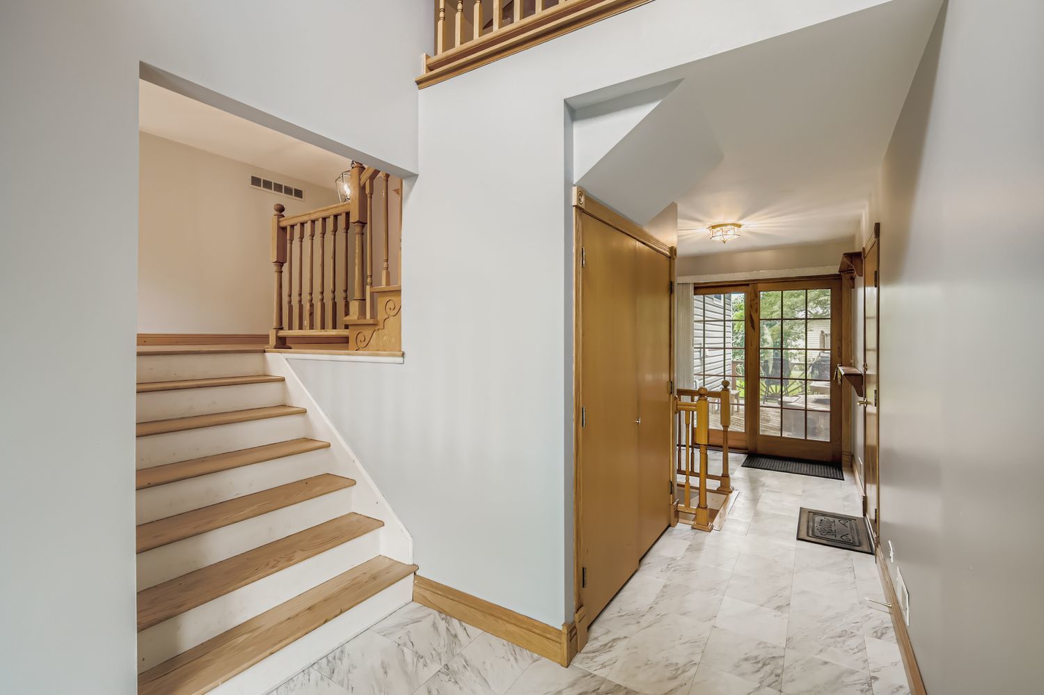 5904 Elm Street Lisle, IL 60532 - Photo 5 of 36 a view of a hallway with windows and stairs