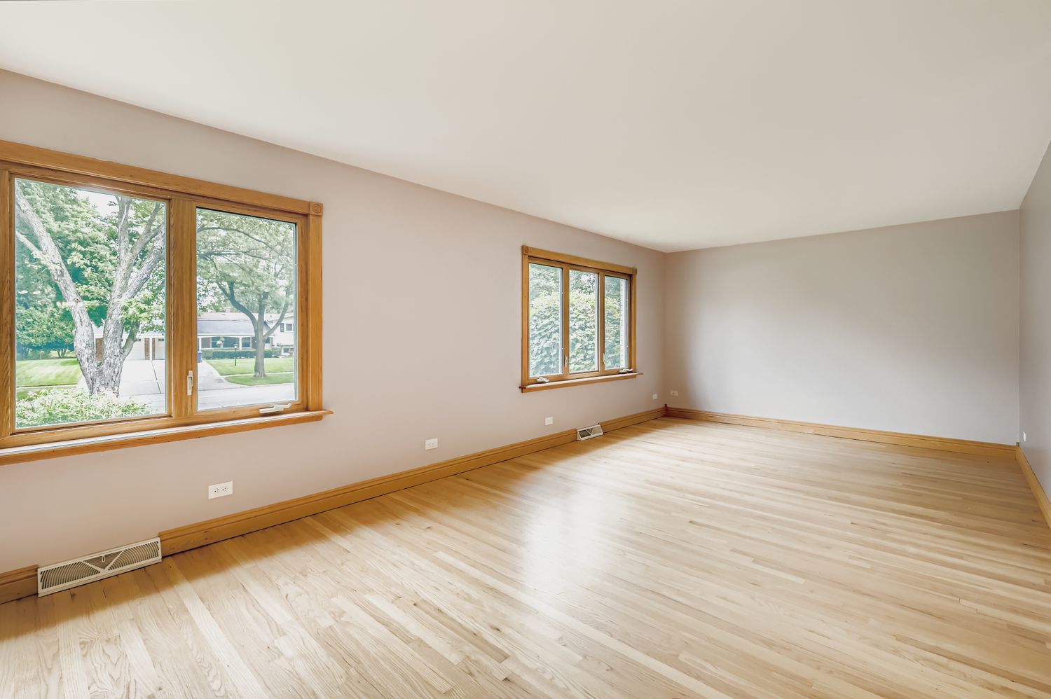 5904 Elm Street Lisle, IL 60532 - Photo 6 of 36 a view of an empty room with wooden floor and a window