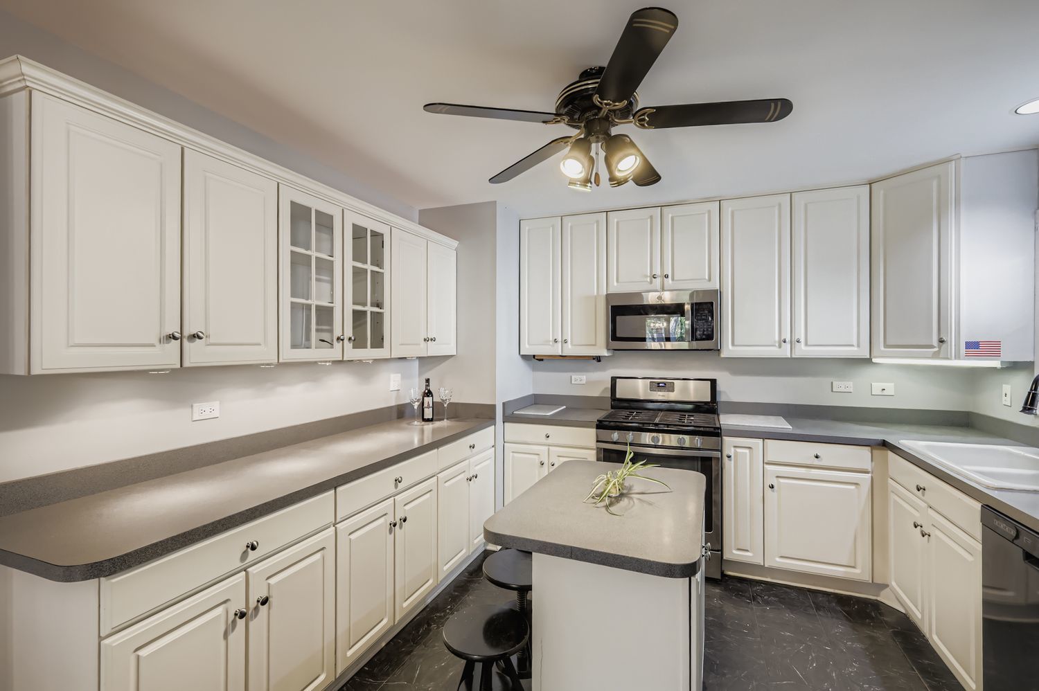 5904 Elm Street Lisle, IL 60532 - Photo 10 of 36 a kitchen with cabinets appliances a sink and a counter top space