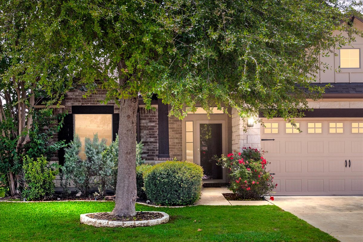 137 Navigator Drive Austin, TX 78717 - Photo 2 of 18 a front view of a house with a yard and potted plants