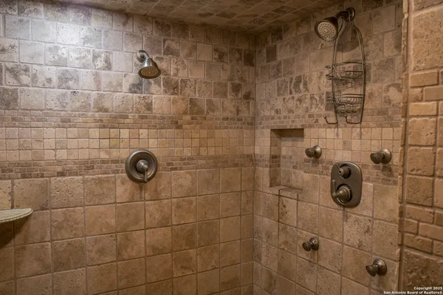 a bathroom with a granite countertop tub sink and mirror
