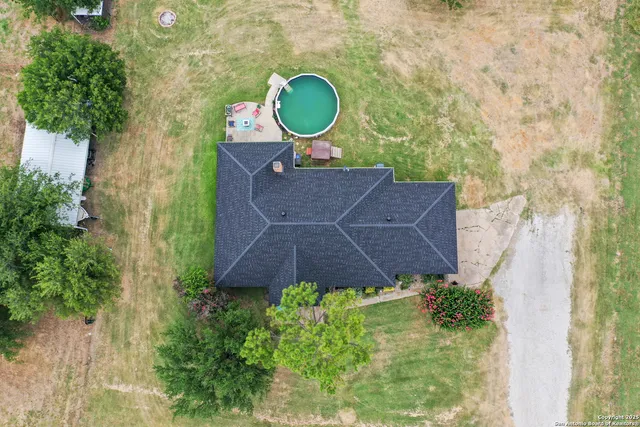 a aerial view of a house with a yard and garden