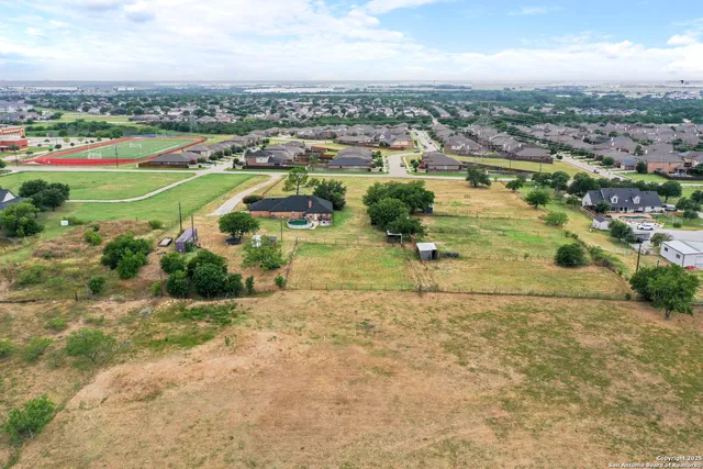 an aerial view of residential houses with outdoor space