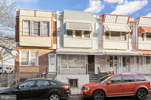 a front view of a house with parking space