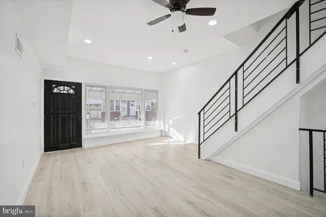 a view of an entryway with wooden floor