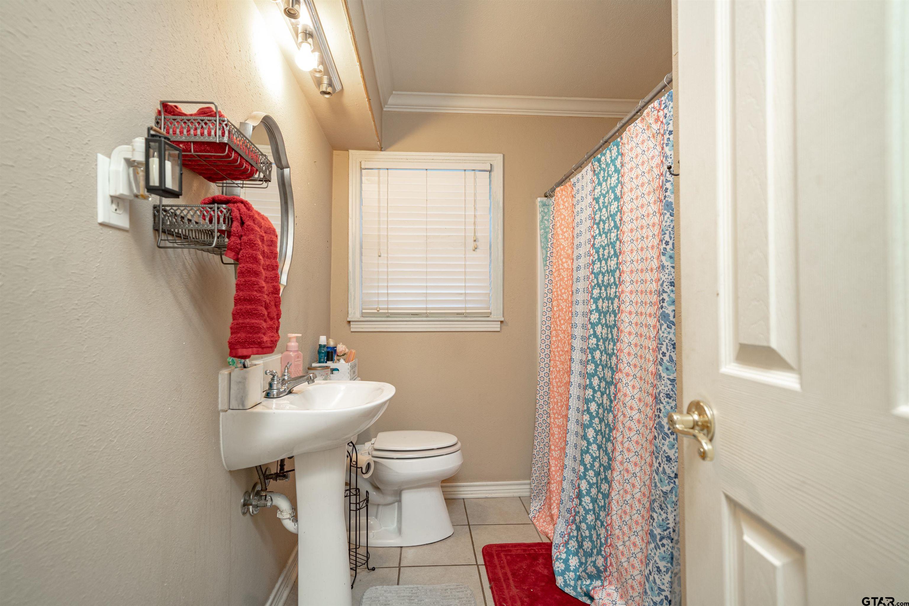 206 Summit Drive Gilmer, TX 75644 - Photo 13 of 24 a bathroom with a sink toilet and shower
