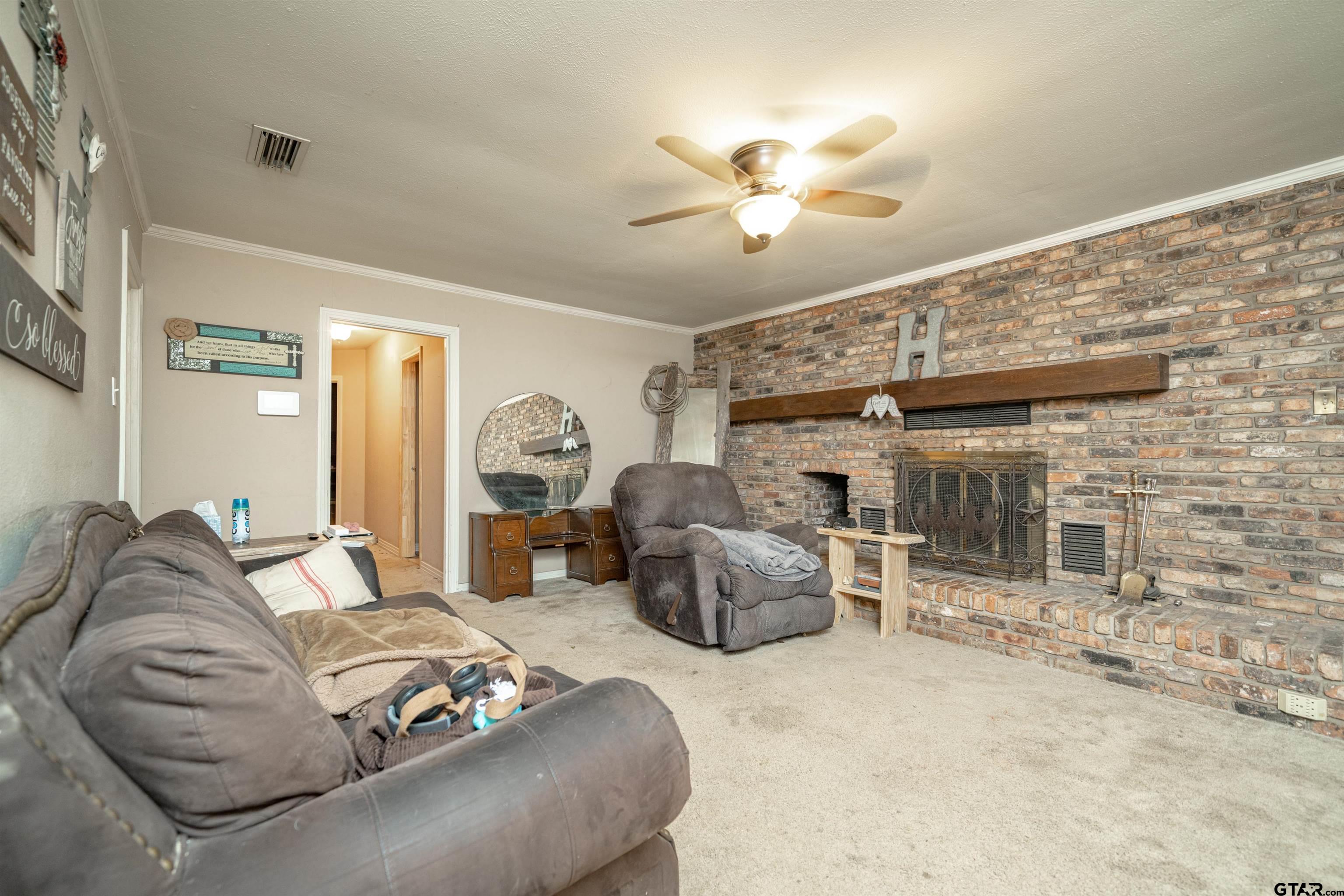 206 Summit Drive Gilmer, TX 75644 - Photo 6 of 24 a living room with furniture a ceiling fan and a rug