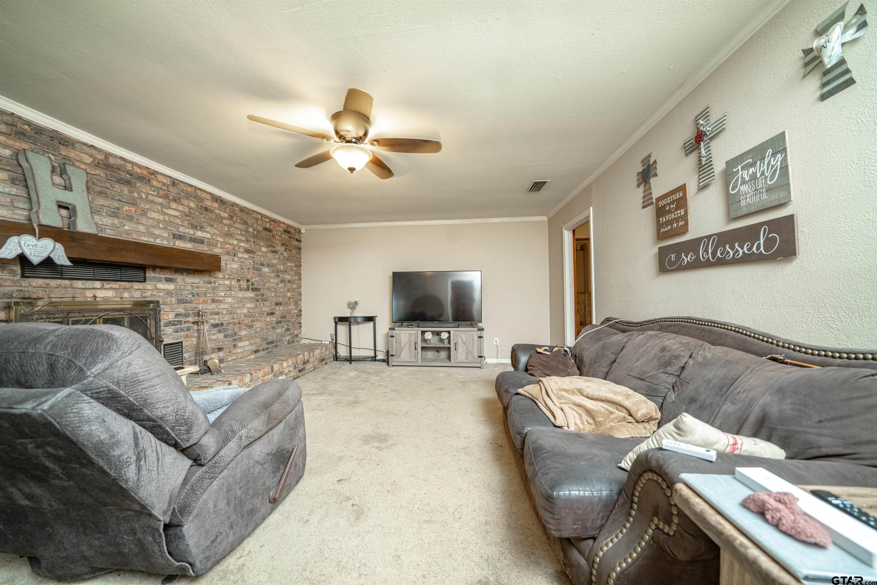 206 Summit Drive Gilmer, TX 75644 - Photo 7 of 24 a living room with furniture and a flat screen tv