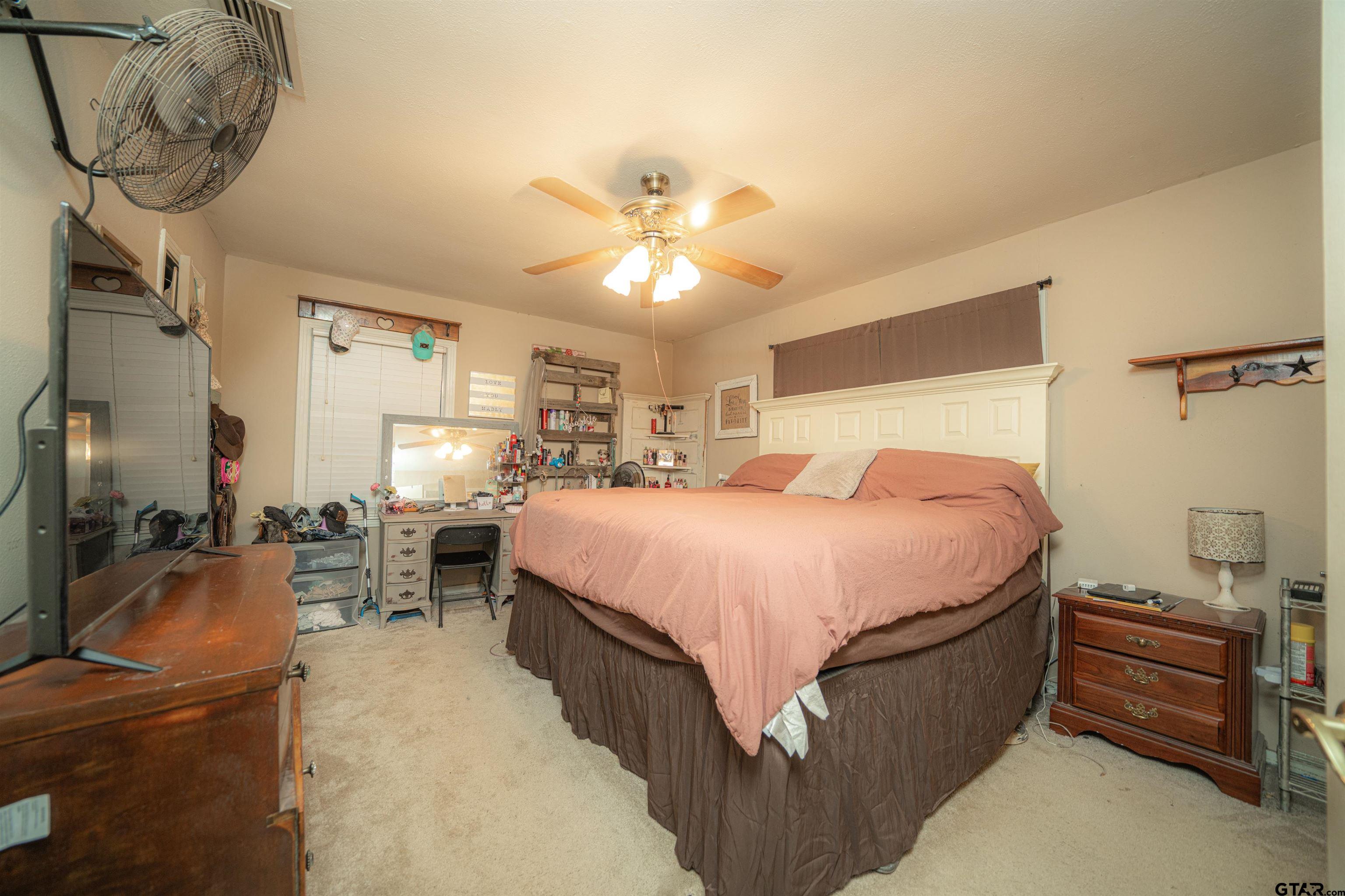 206 Summit Drive Gilmer, TX 75644 - Photo 10 of 24 a bedroom with a bed and a chandelier