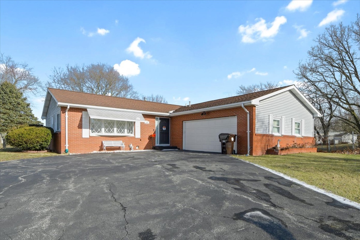 a view of a house with a yard and garage