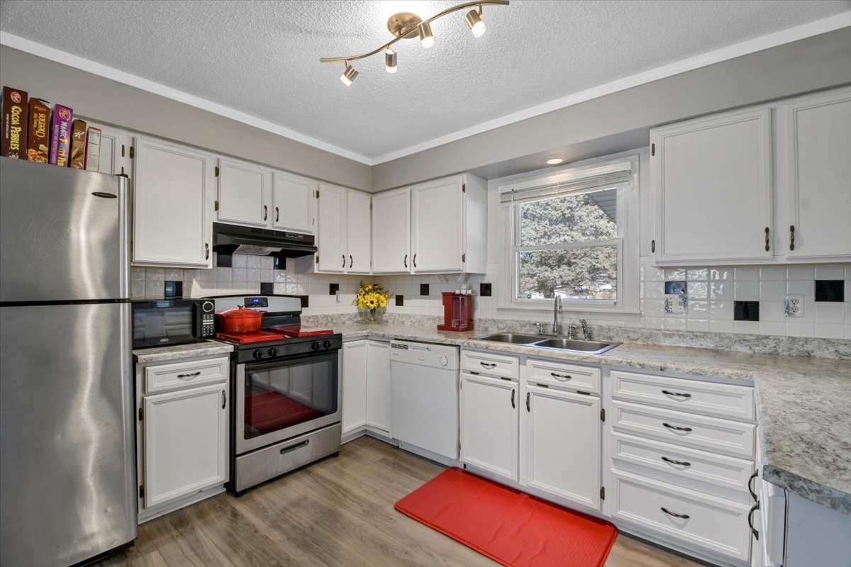 275 Alexander Drive Rantoul, IL 61866 - Photo 17 of 24 a kitchen with granite countertop a sink stainless steel appliances and cabinets