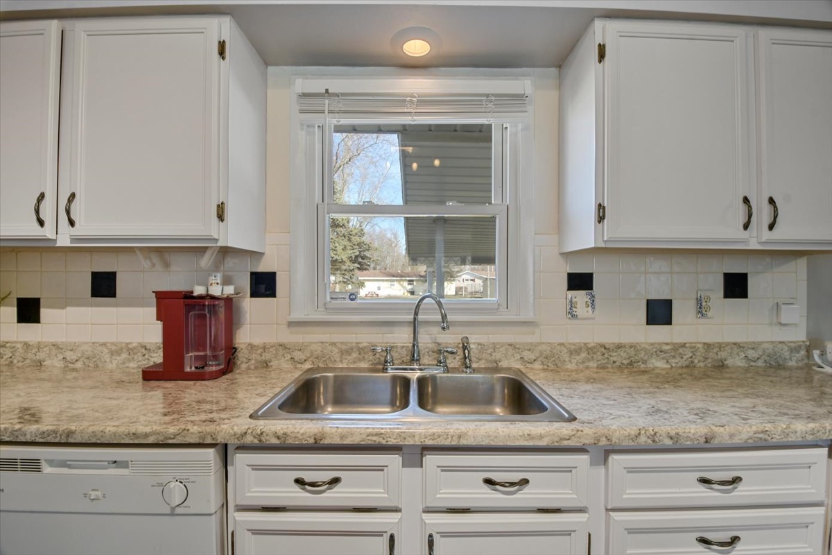 275 Alexander Drive Rantoul, IL 61866 - Photo 18 of 24 a kitchen with granite countertop a sink and white cabinets
