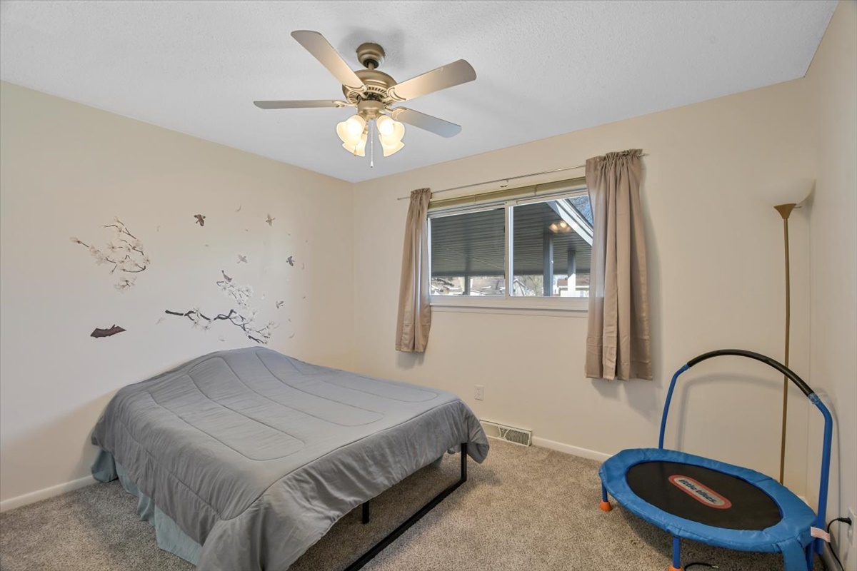 275 Alexander Drive Rantoul, IL 61866 - Photo 3 of 24 a bedroom with a bed and a potted plant